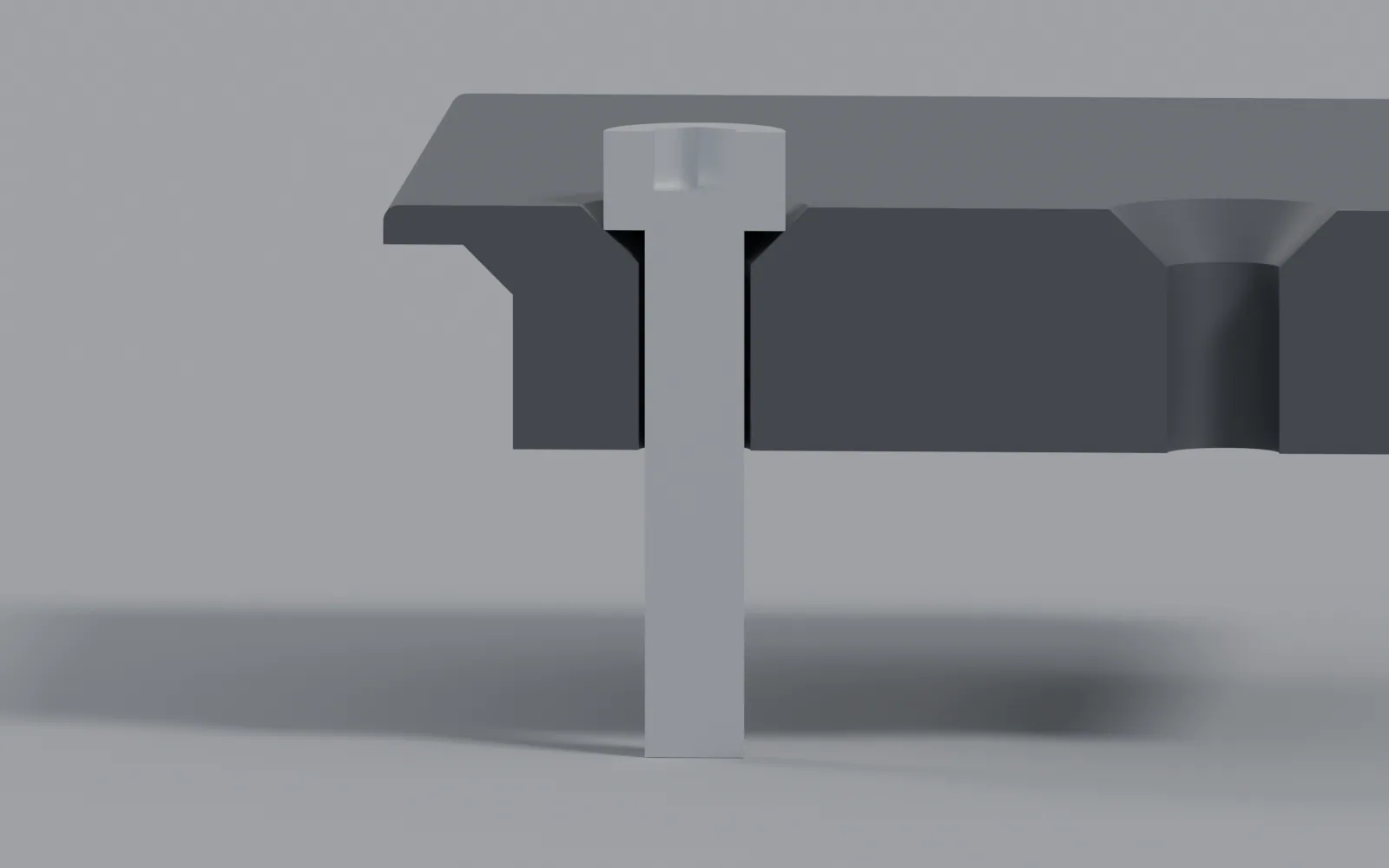 A cap screw through the rail, tip sticking out the back